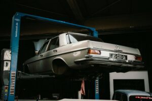 A classic Mercedes-Benz elevated in a car workshop, perfect for automotive themes.